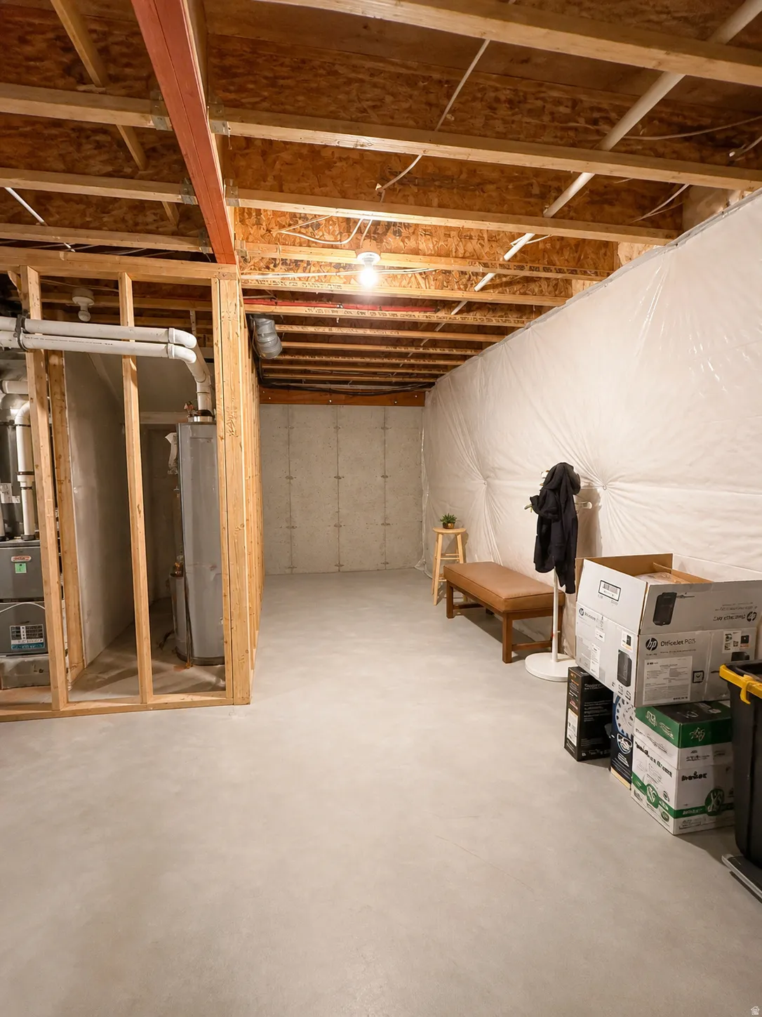Unfinished below grade area featuring water heater