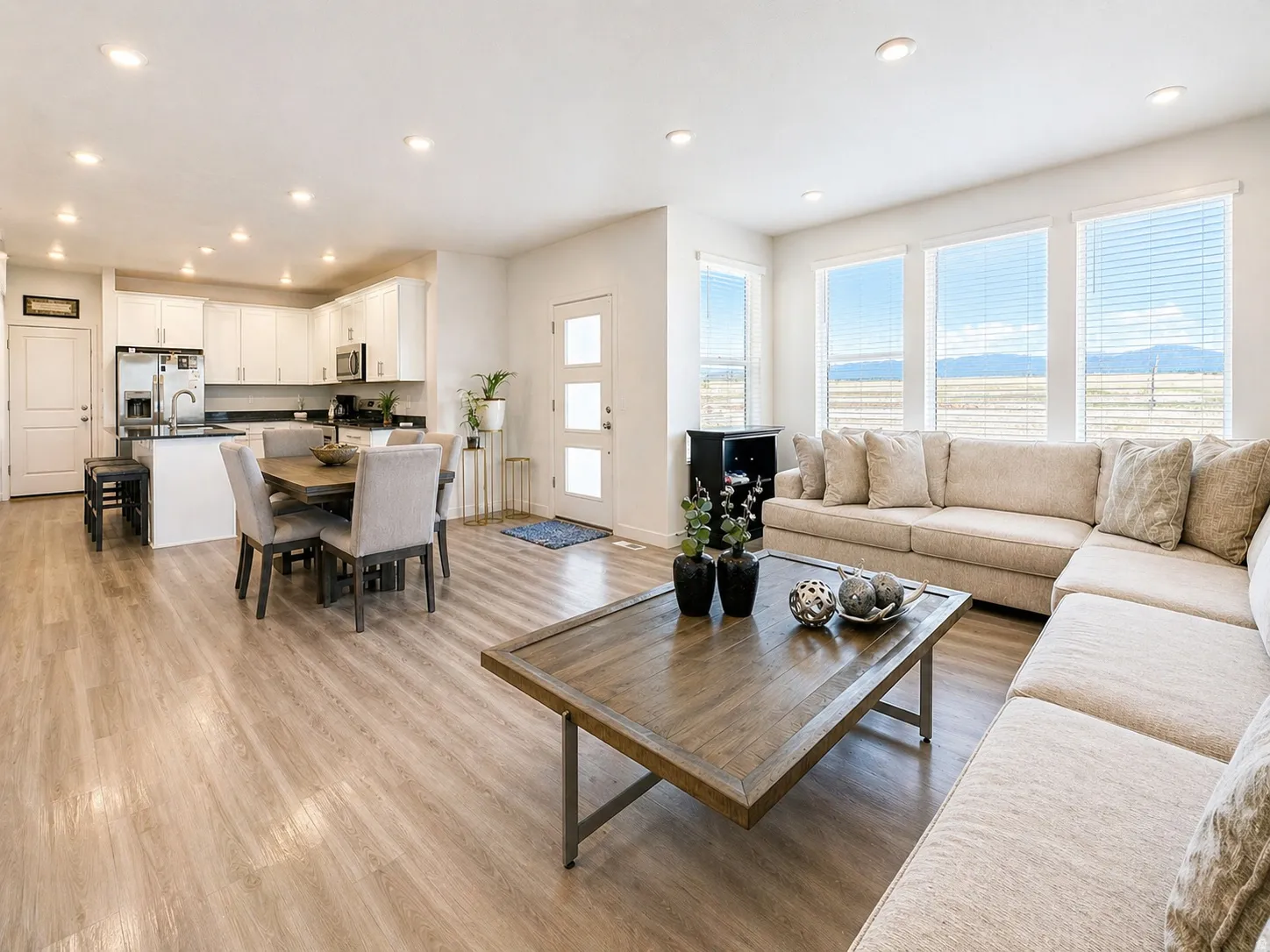 Living room with light wood-style flooring and recessed lighting