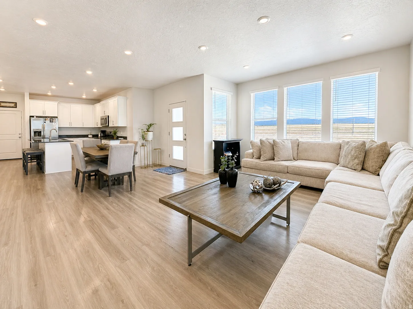 Living room featuring light wood-type flooring, recessed lighting, and a textured ceiling
