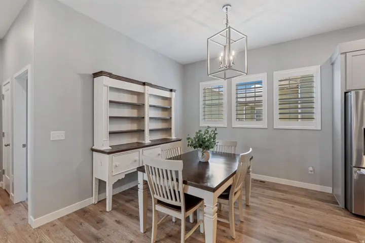 Dining space featuring light wood-style floors and hanging lights
