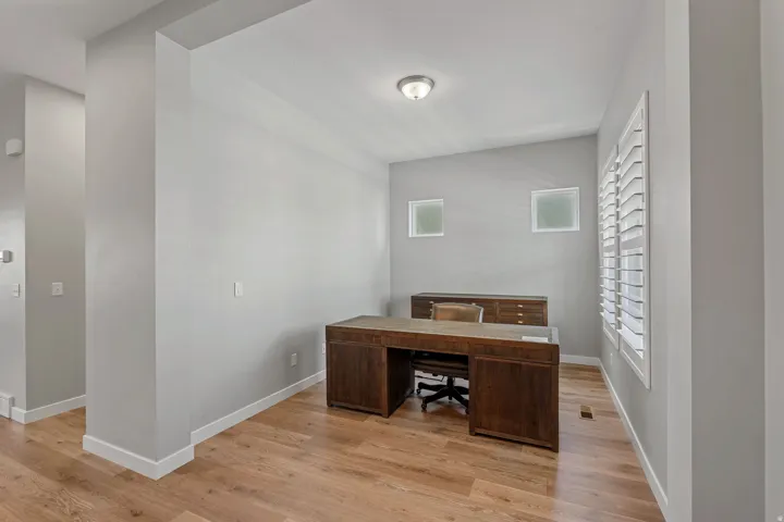 Unfurnished office with light wood-style floors and baseboards