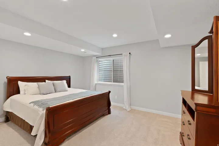 Bedroom featuring light colored carpet and recessed lighting