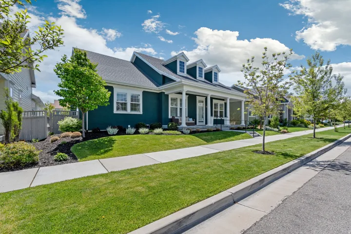 Cape cod-style house with a porch and a shingled roof
