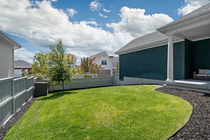 Fenced backyard featuring a residential view