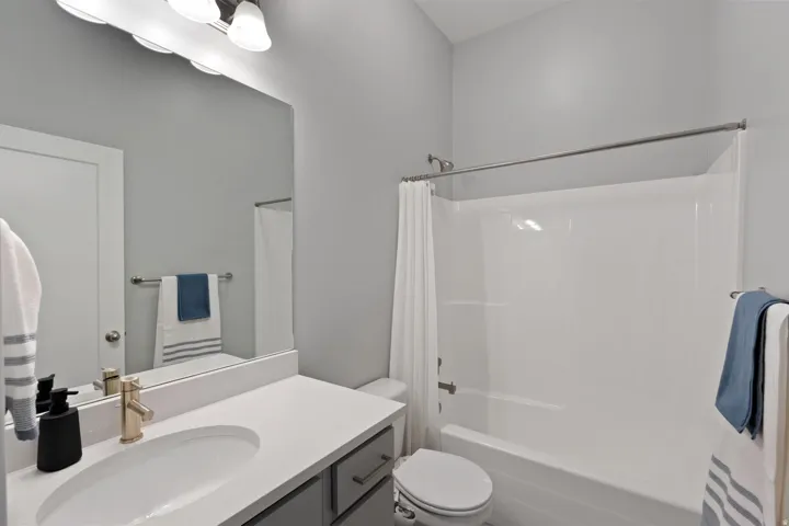 Bathroom with vanity and shower / bath combo with shower curtain