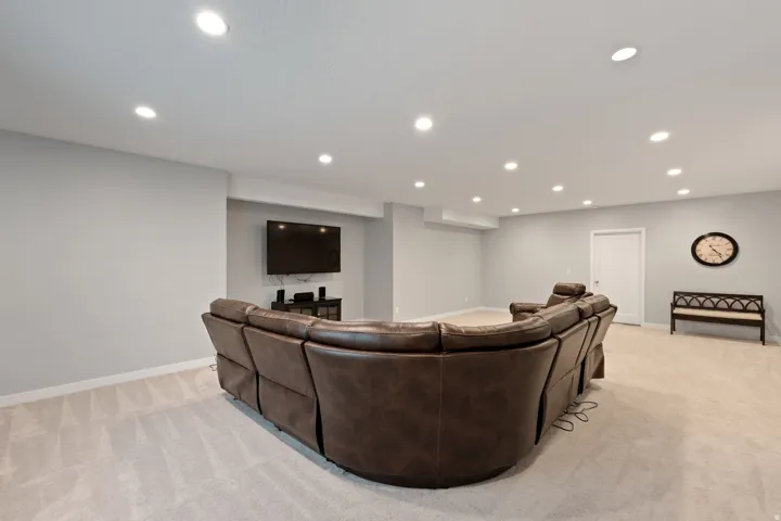 Living room with light carpet and recessed lighting