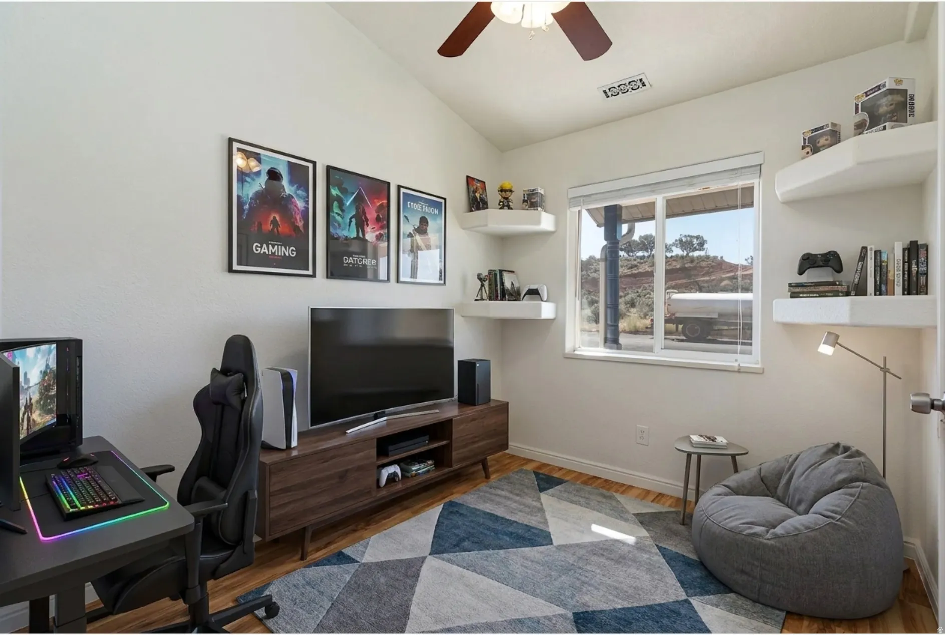 Office area featuring wood finished floors, vaulted ceiling, and ceiling fan