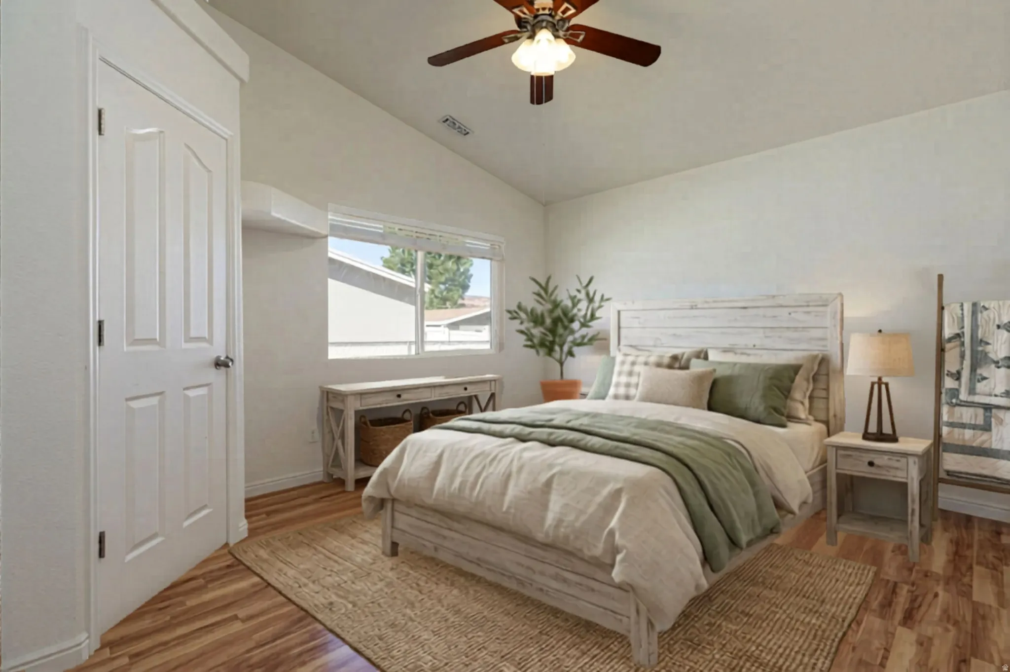 Bedroom with lofted ceiling, light wood-style floors, and a ceiling fan
