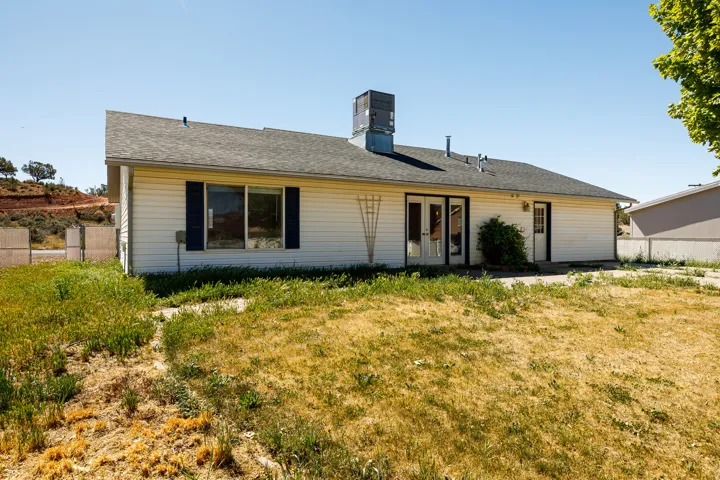 Single story home featuring french doors, a chimney, and a shingled roof