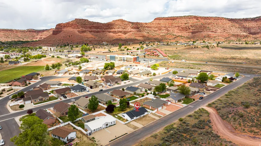 Aerial perspective of suburban area with a mountain backdrop