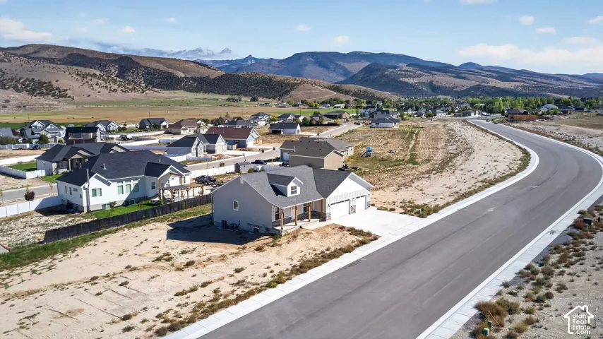 Newly constructed home with an attached two-car garage, covered porch, and asphalt driveway