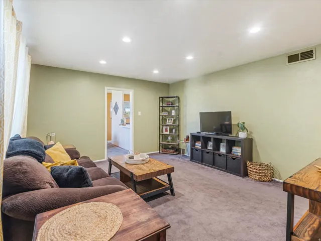 Living room featuring recessed lighting and carpet