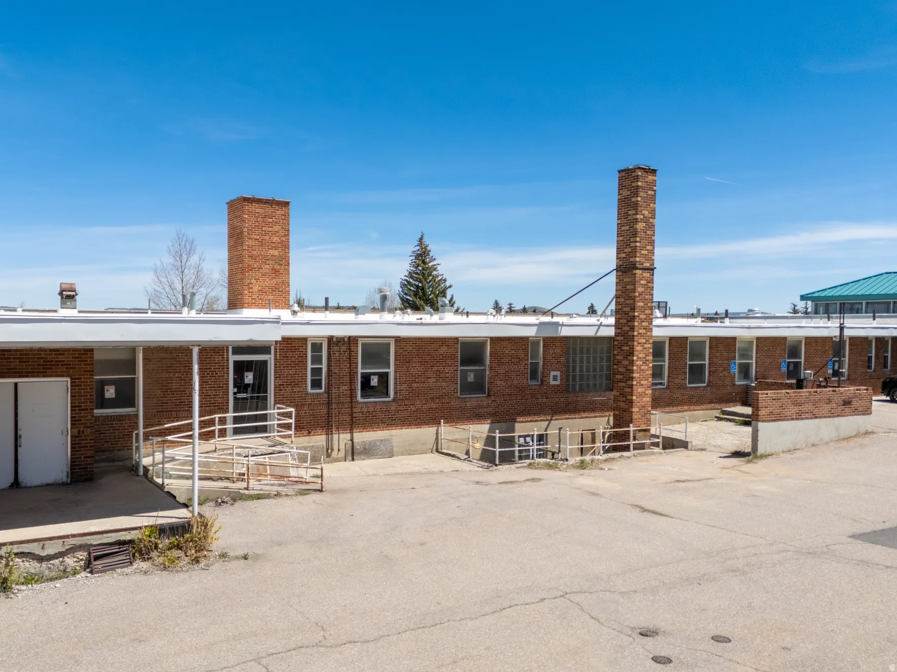 Brick exterior with multiple windows and a flat roofline