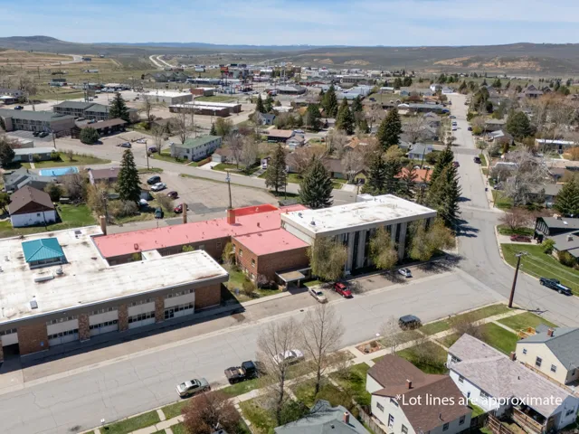 Commercial property featuring multiple buildings with flat roofs, brick facades, and ample paved parking