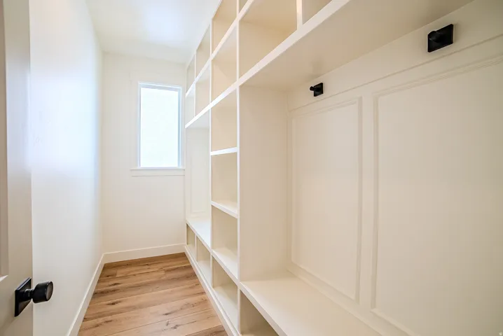 Mudroom featuring light wood-type flooring and baseboards