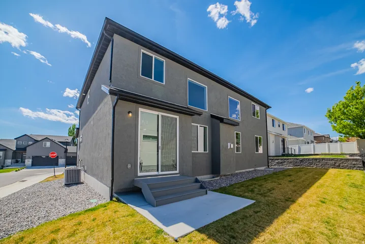 Back of house featuring stucco siding and a residential view