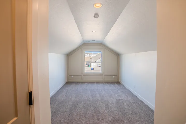 Additional living space with carpet and a textured ceiling
