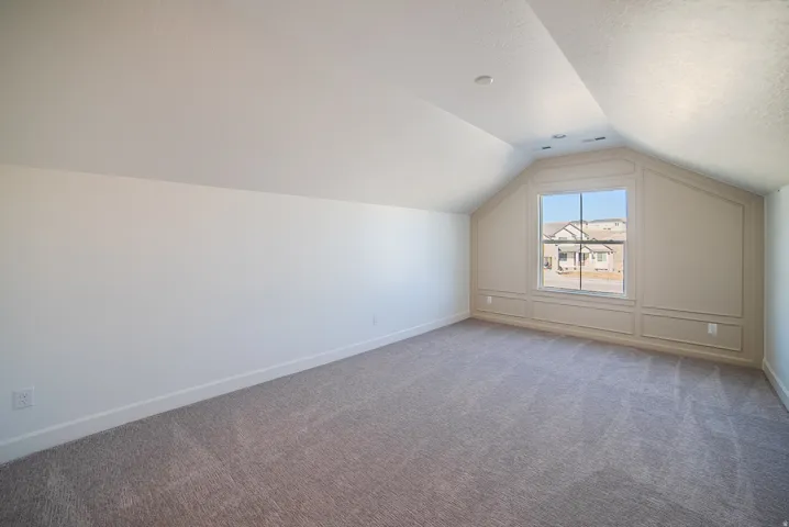 Additional living space with carpet flooring and a textured ceiling
