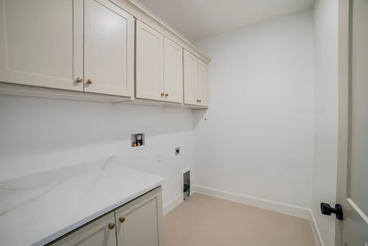 Laundry area featuring washer hookup, electric dryer hookup, and cabinet space
