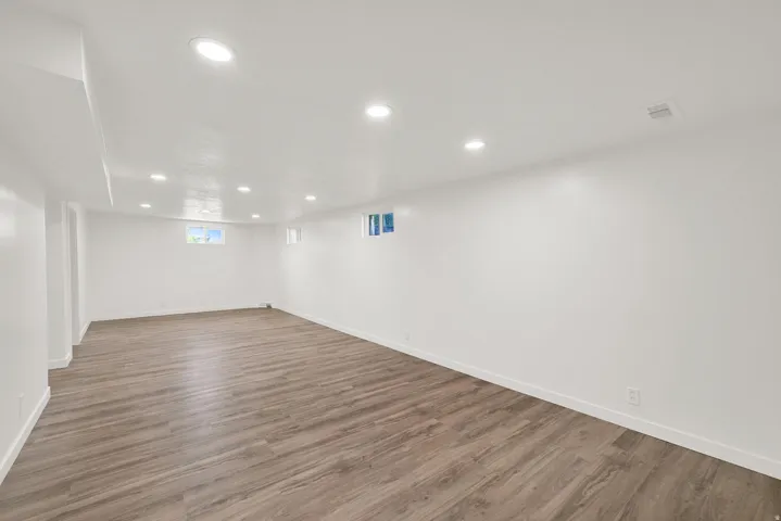 Basement featuring recessed lighting and dark wood-style floors