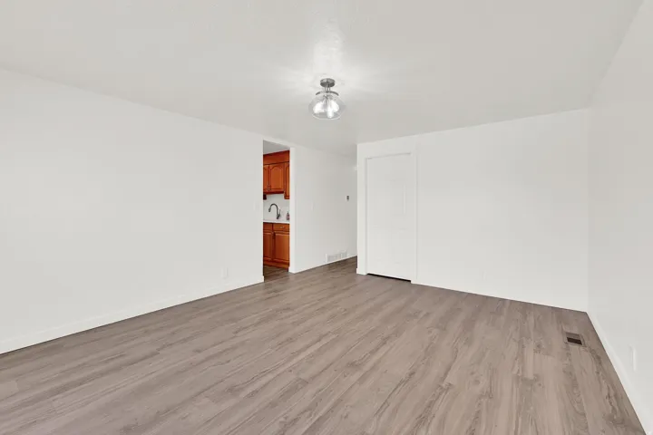Unfurnished room with light wood-style flooring and baseboards