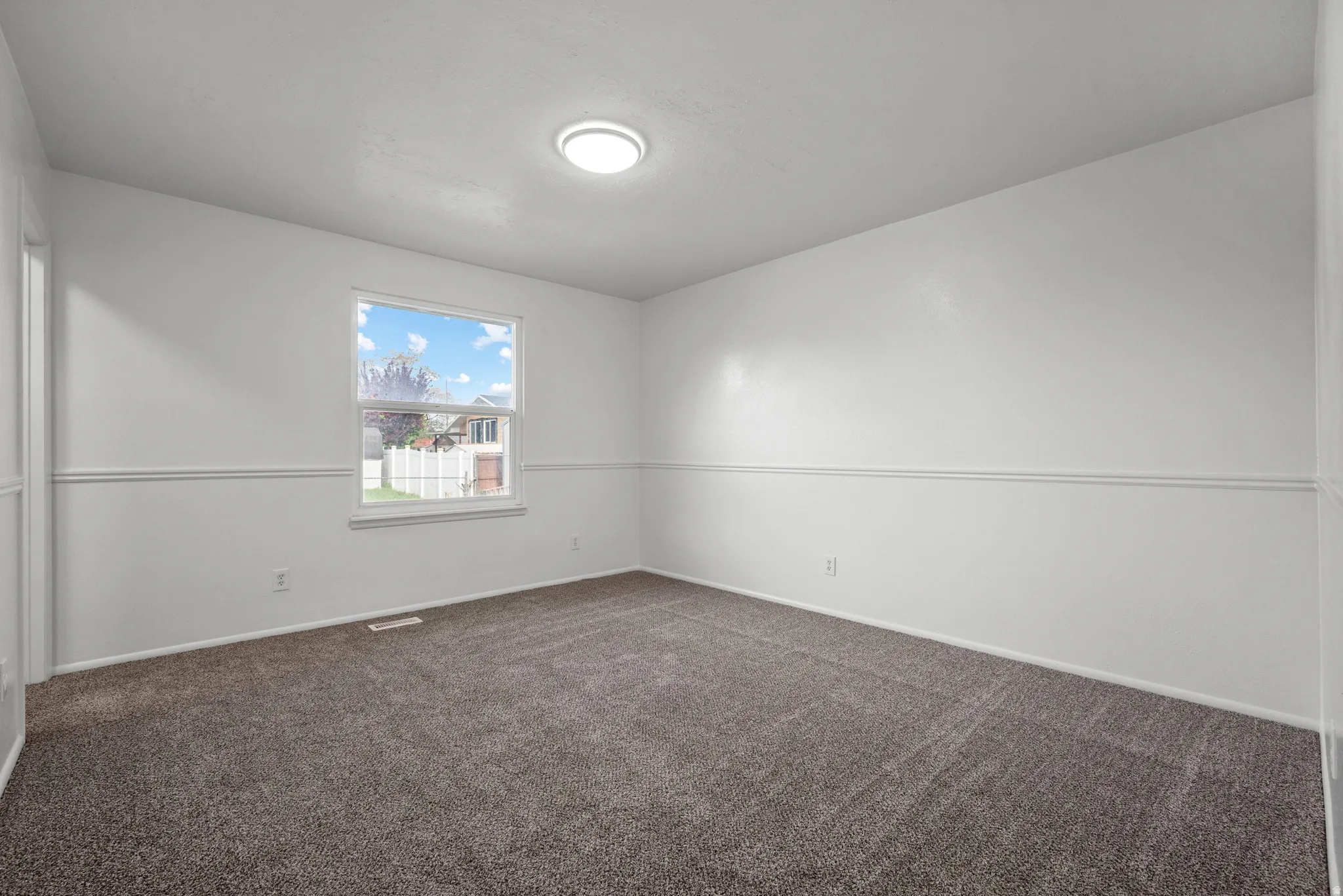 Neutral tone wall paint with decorative chair rail molding
