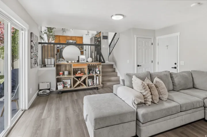 Living room featuring stairway and light wood-style floors