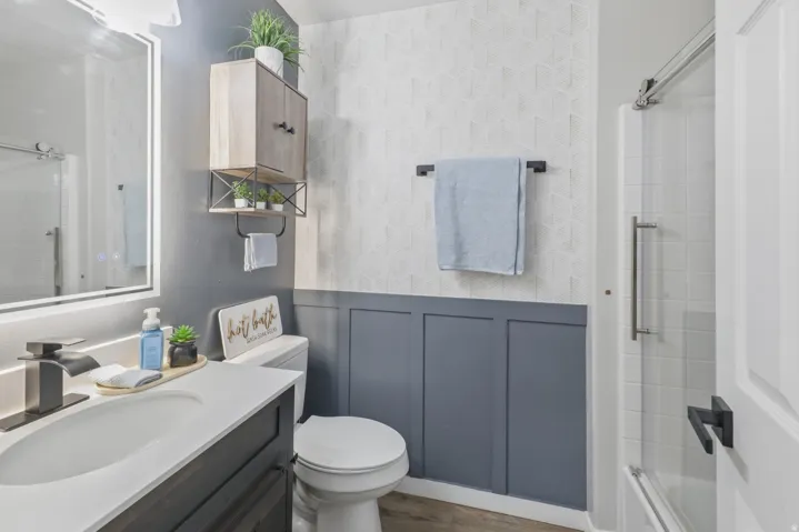 Full bathroom with vanity and bath / shower combo with glass door