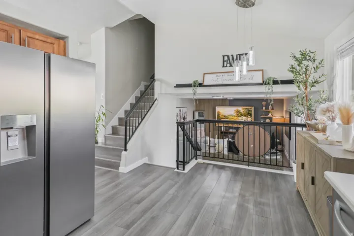 Living area with light wood-type flooring and stairs