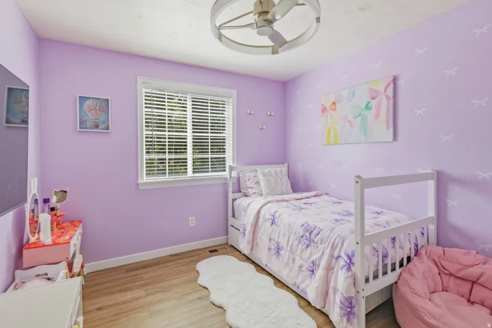 Bedroom featuring light wood finished floors and a ceiling fan