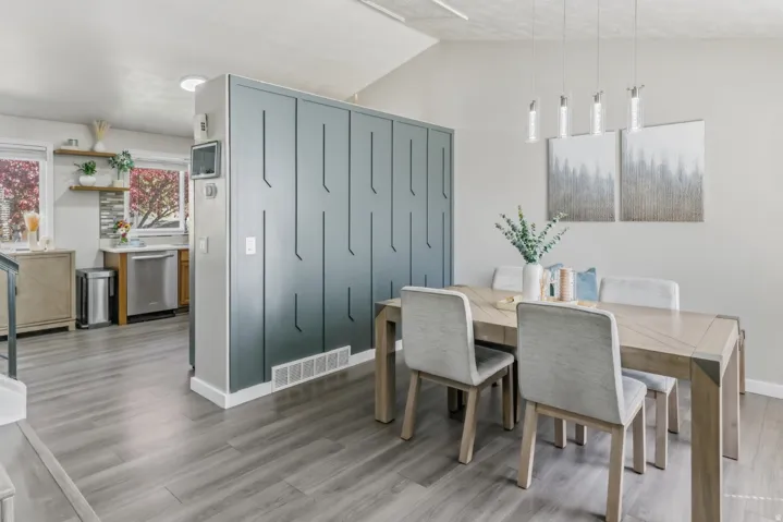 Dining area featuring light wood finished floors and vaulted ceiling