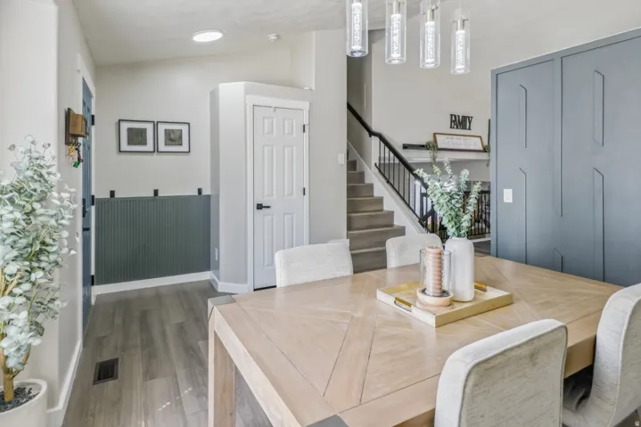Dining area with vaulted ceiling and wood finished floors