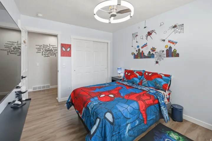 Bedroom with light wood-type flooring, a closet, and ceiling fan