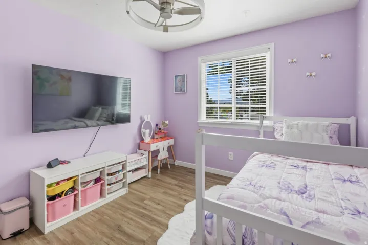 Bedroom featuring light wood finished floors and a ceiling fan