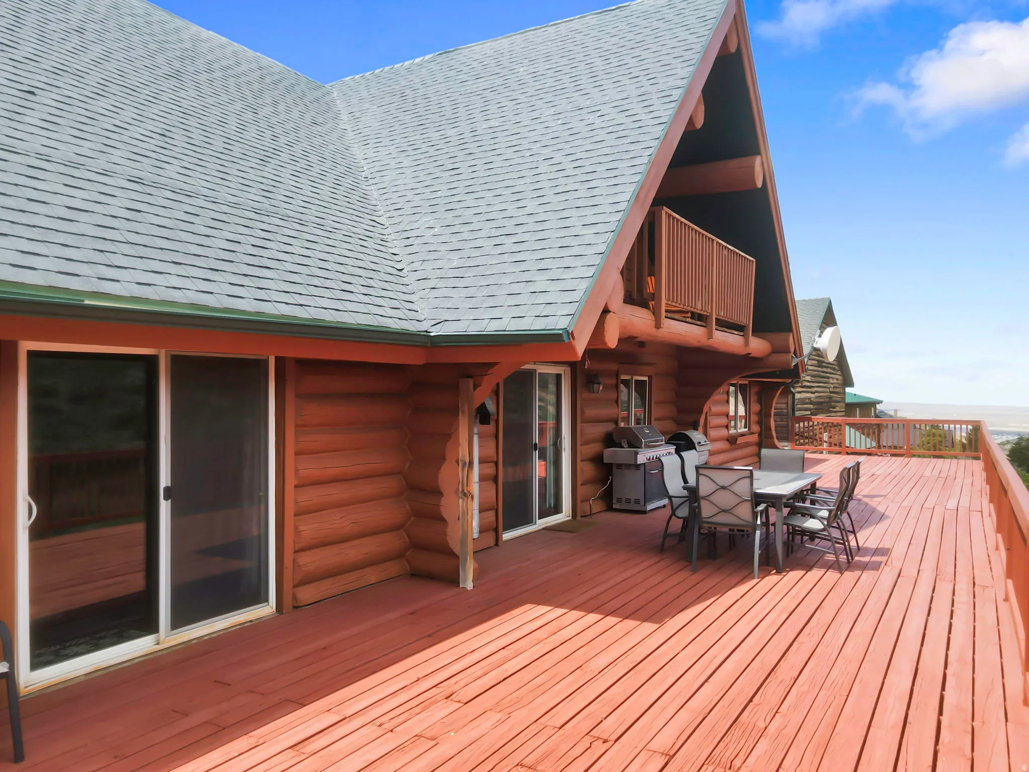 Expansive outdoor deck featuring wood-finish flooring