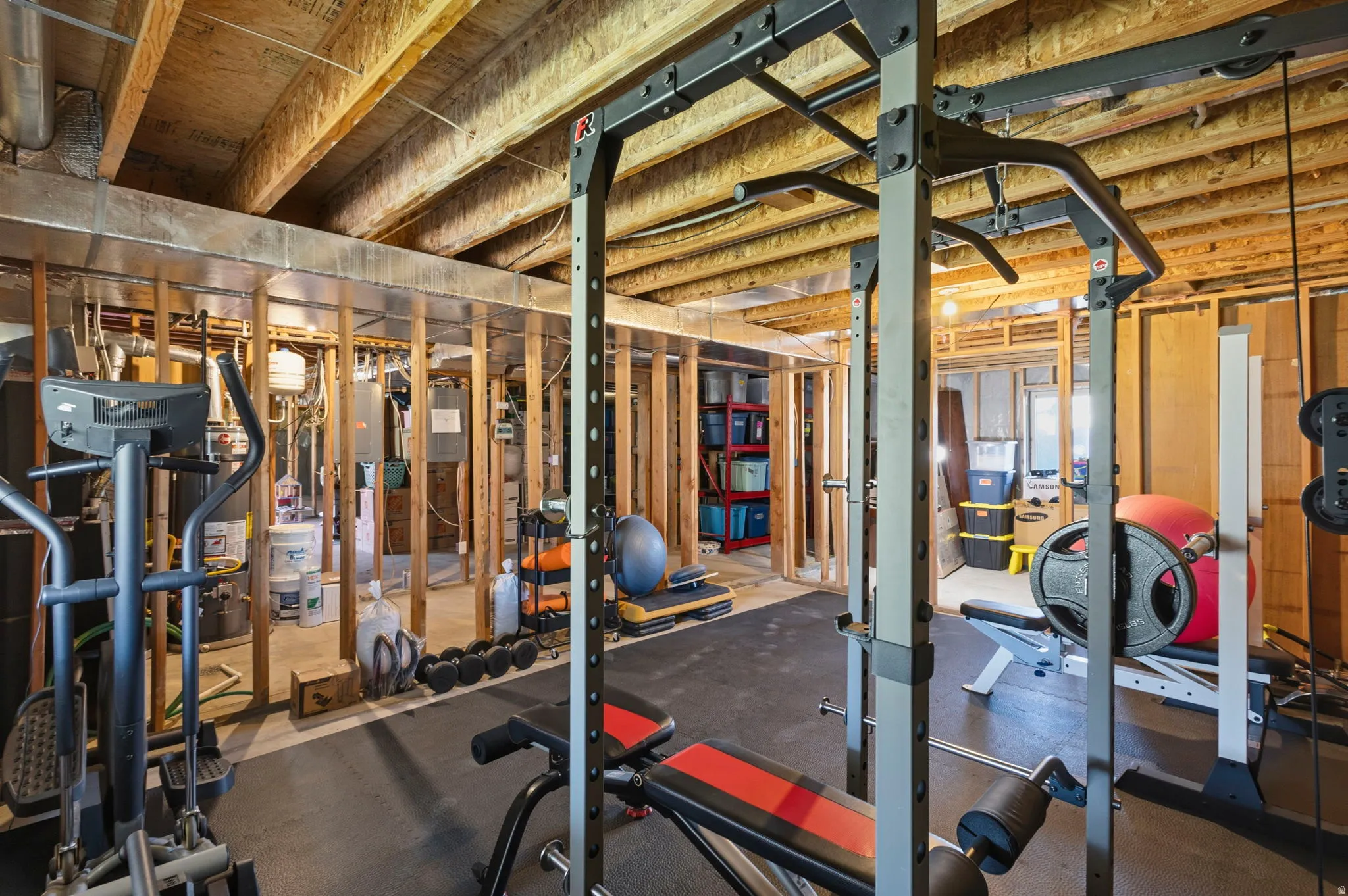 Workout room with water heater and rubber floors