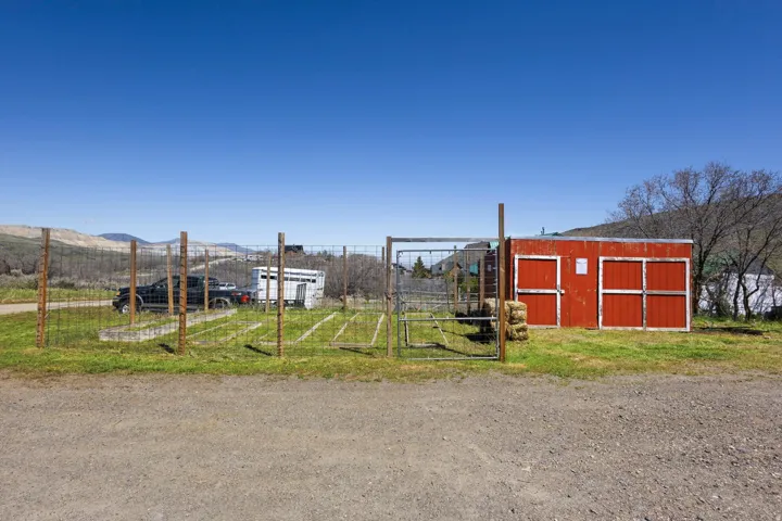 View of outdoor structure featuring a gate and a mountain view