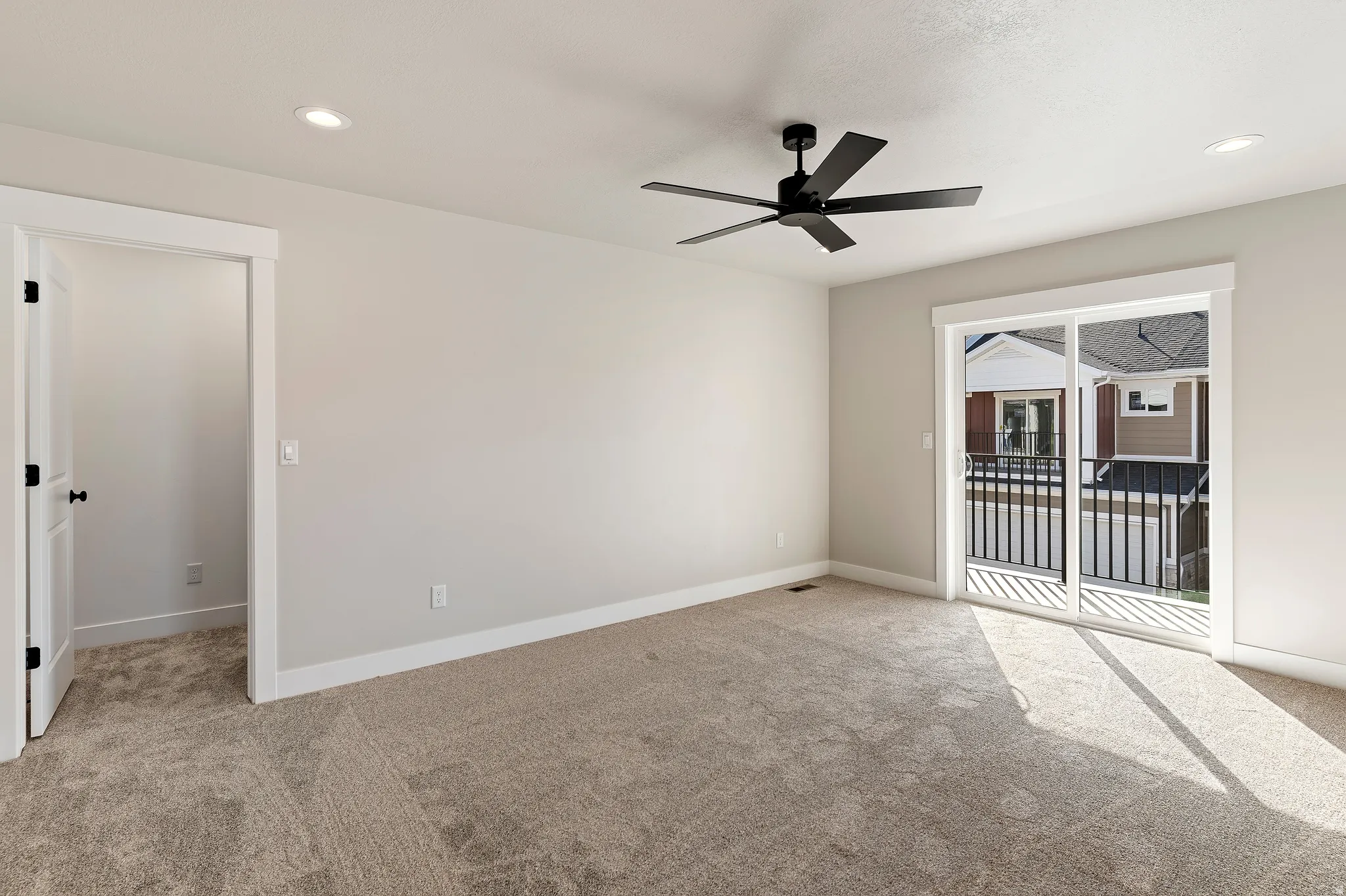 Spacious room featuring neutral carpeting and light-toned walls