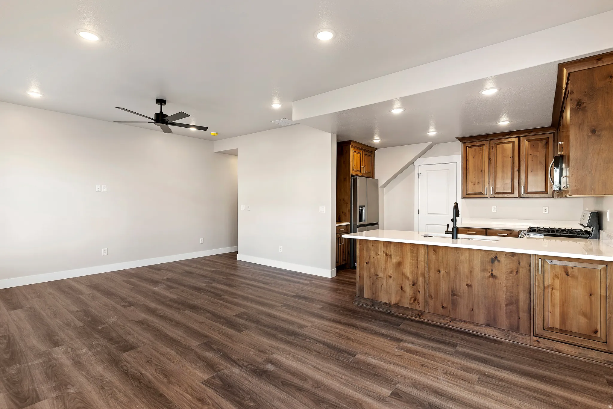 Open-concept living space featuring wood-finish flooring throughout