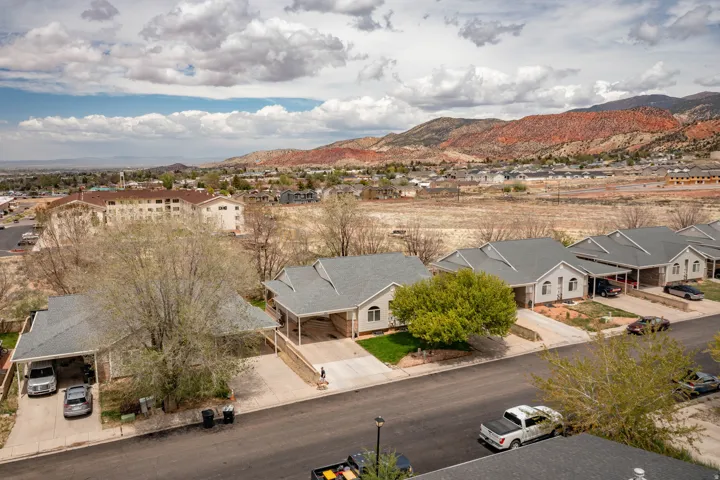 Aerial perspective showcasing residential properties with a mountainous backdrop