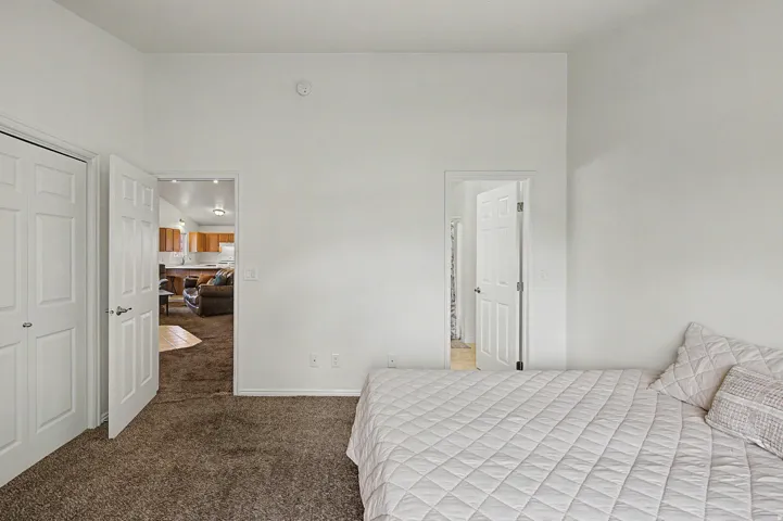 Spacious room featuring neutral carpet flooring and white walls