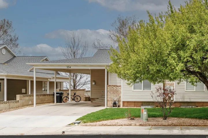 Light-colored vinyl siding exterior with brick accents