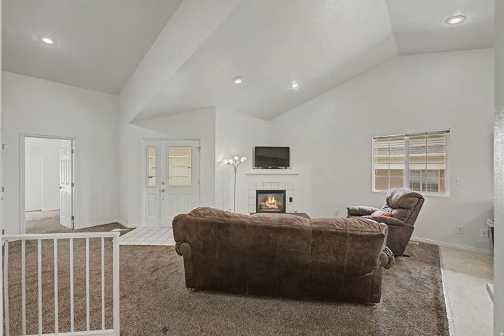 Living area featuring vaulted ceilings and recessed lighting