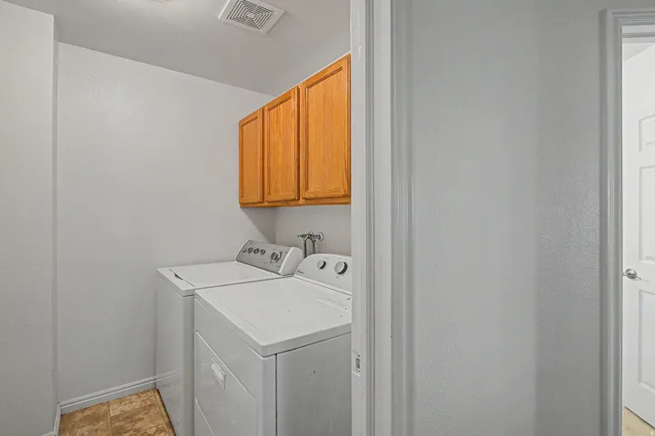 Dedicated laundry area featuring overhead cabinetry- Washer/Dryer Negotiable