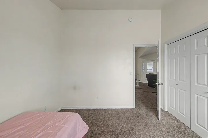 Neutral-toned walls and carpeted flooring in a bright room