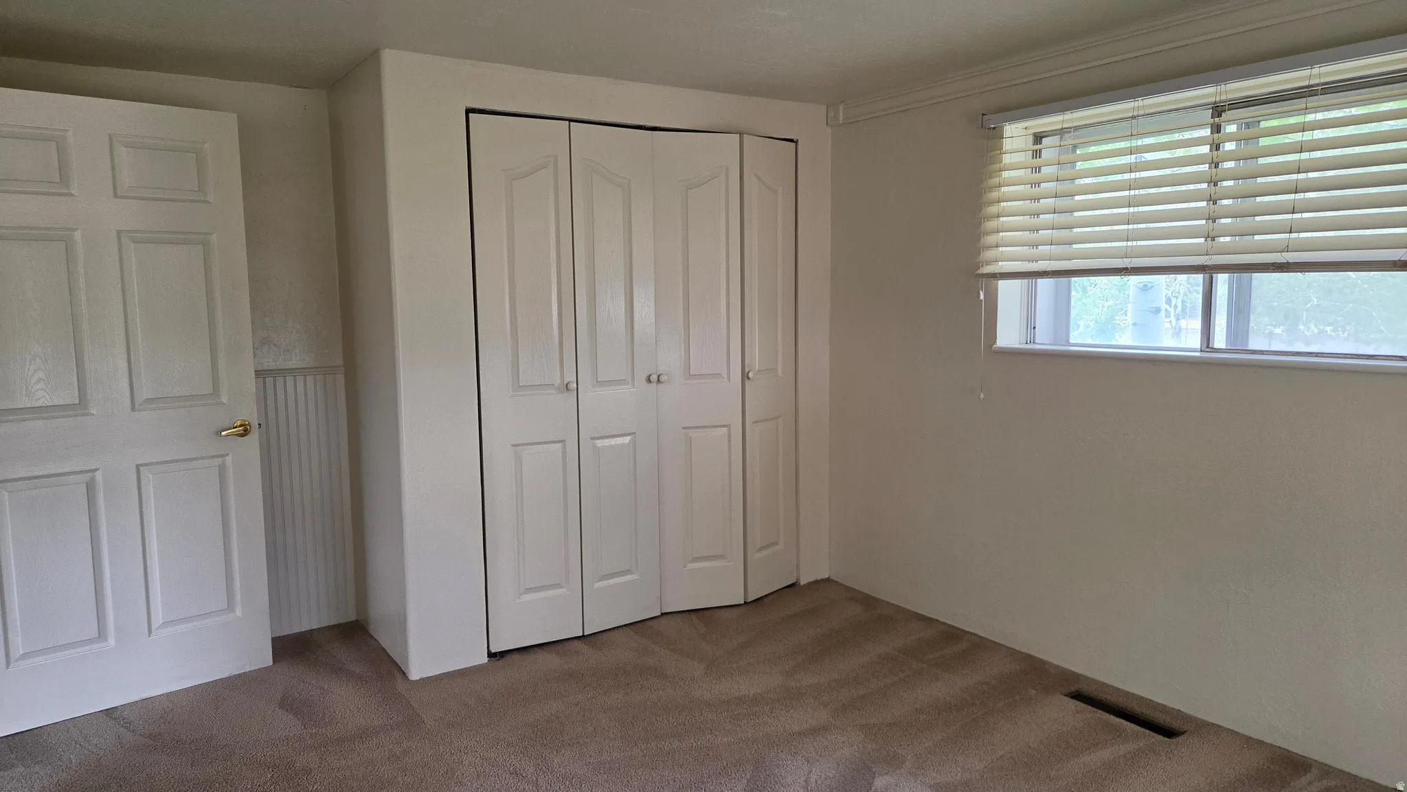 Neutral tone wall finishes complemented by light beige carpeting