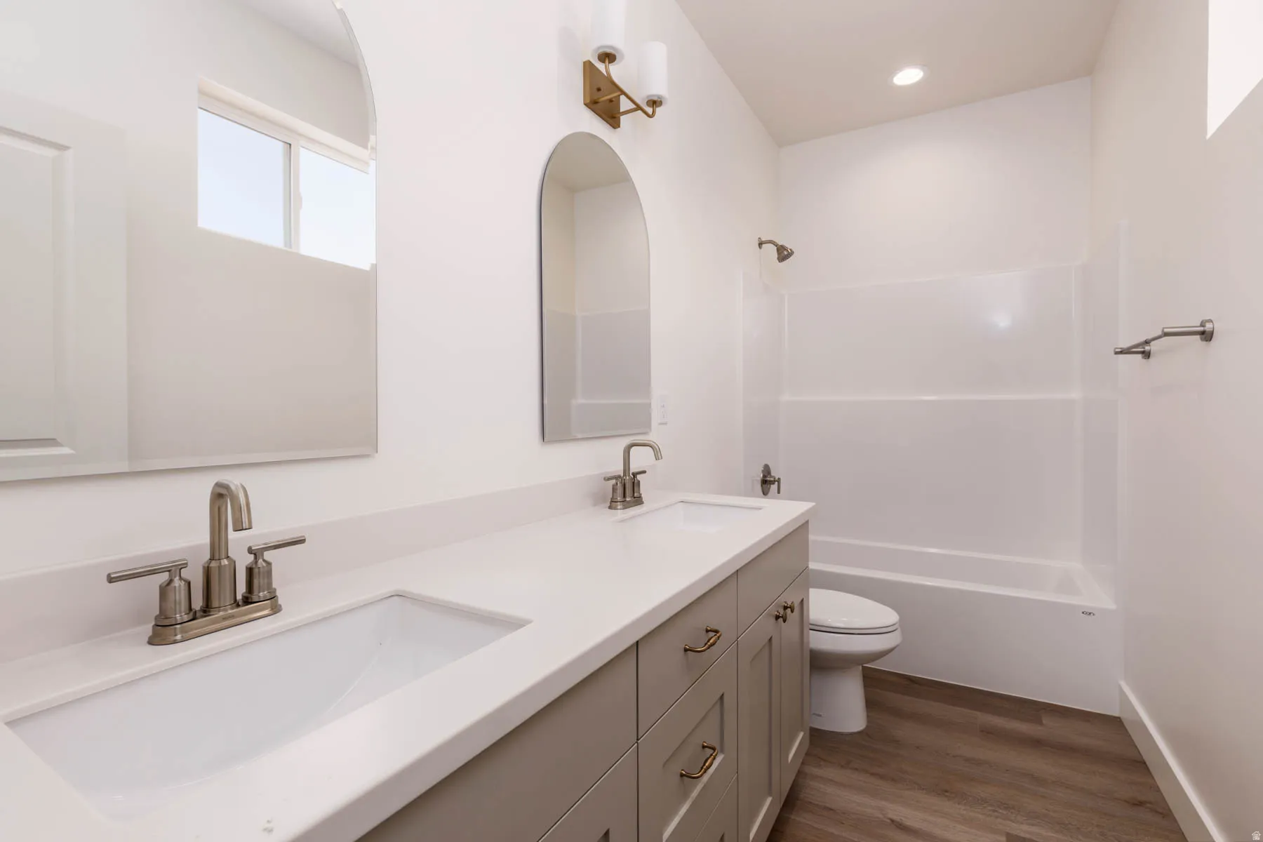 Bathroom featuring a dual vanity with a light gray cabinet base, white countertop, and integrated sinks