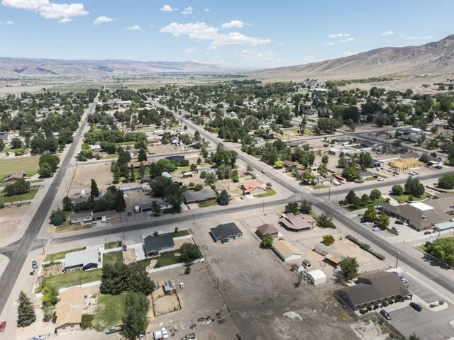 Elevated aerial perspective showcasing a community with established tree canopies and residential structures