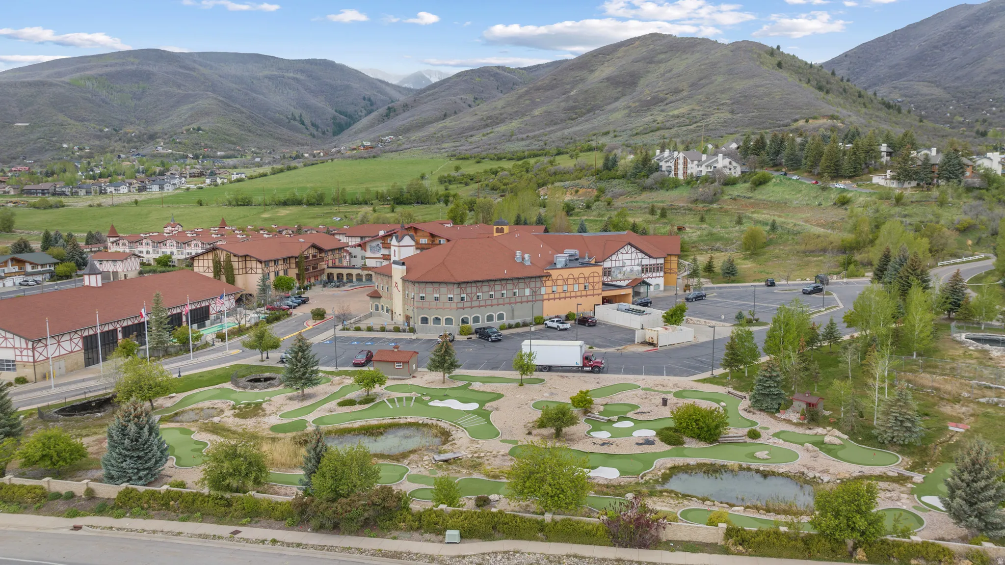 Expansive grounds featuring a miniature golf course with water features and mature landscaping