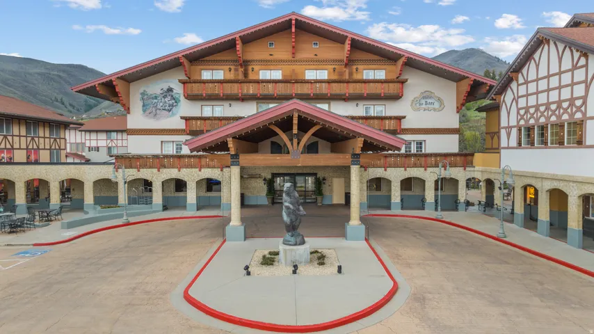 Grand Bavarian-style facade featuring multiple tiers of balconies, intricate timber detailing, and an arched entryway